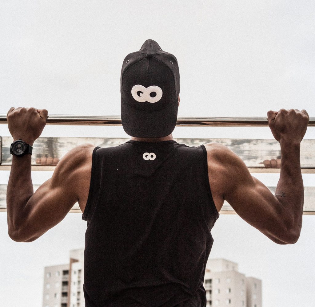 man doing a pullup, shot from behind
